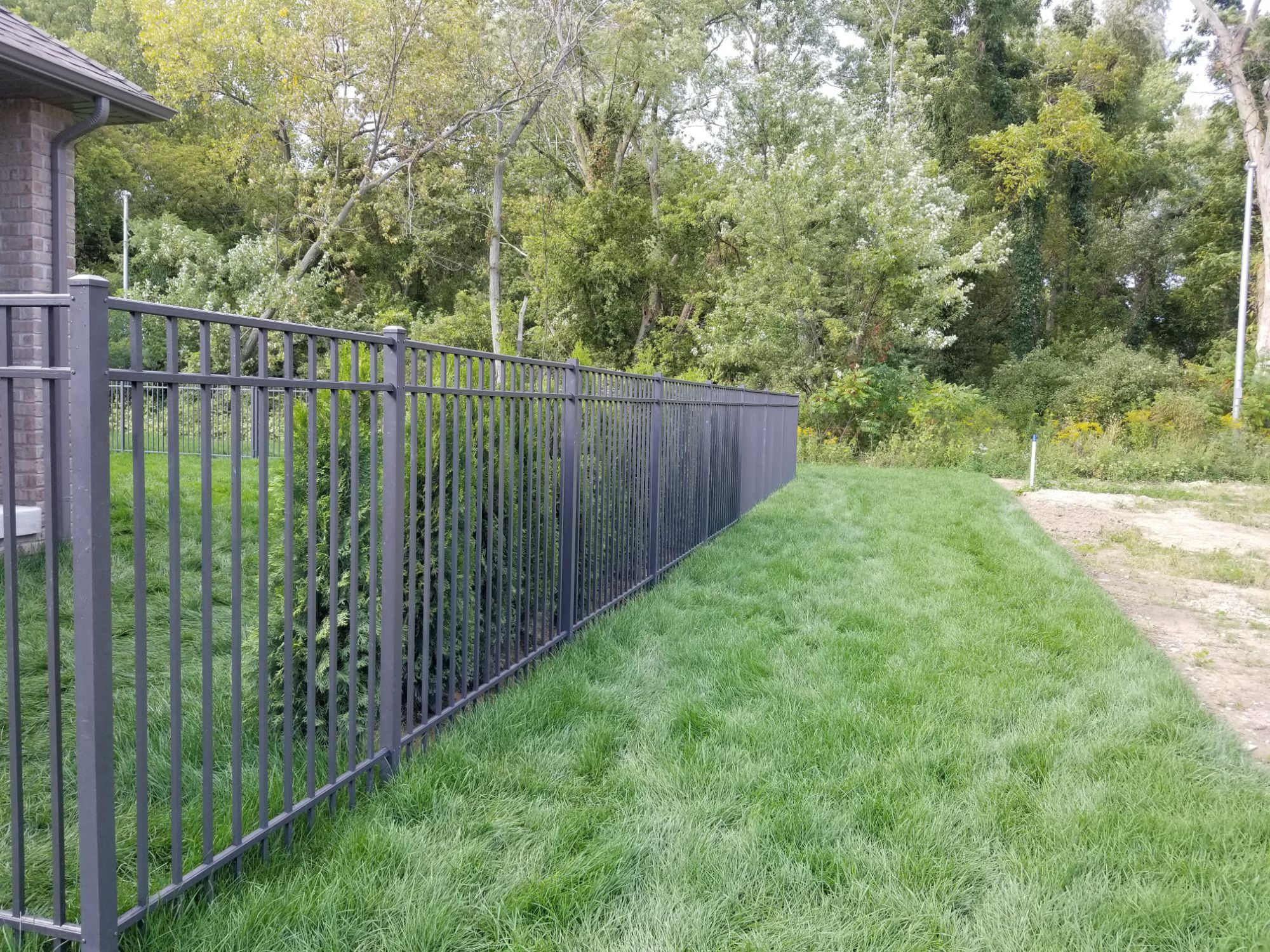 In Kingsville, we installed this 5-foot fence for a wonderful couple who wanted something safe and secure for their dog. Yorktown aluminum, with three horizontal rails, this fence sets a style without dominating the yard. The neighbors liked it so much that we returned the following year to do their house.