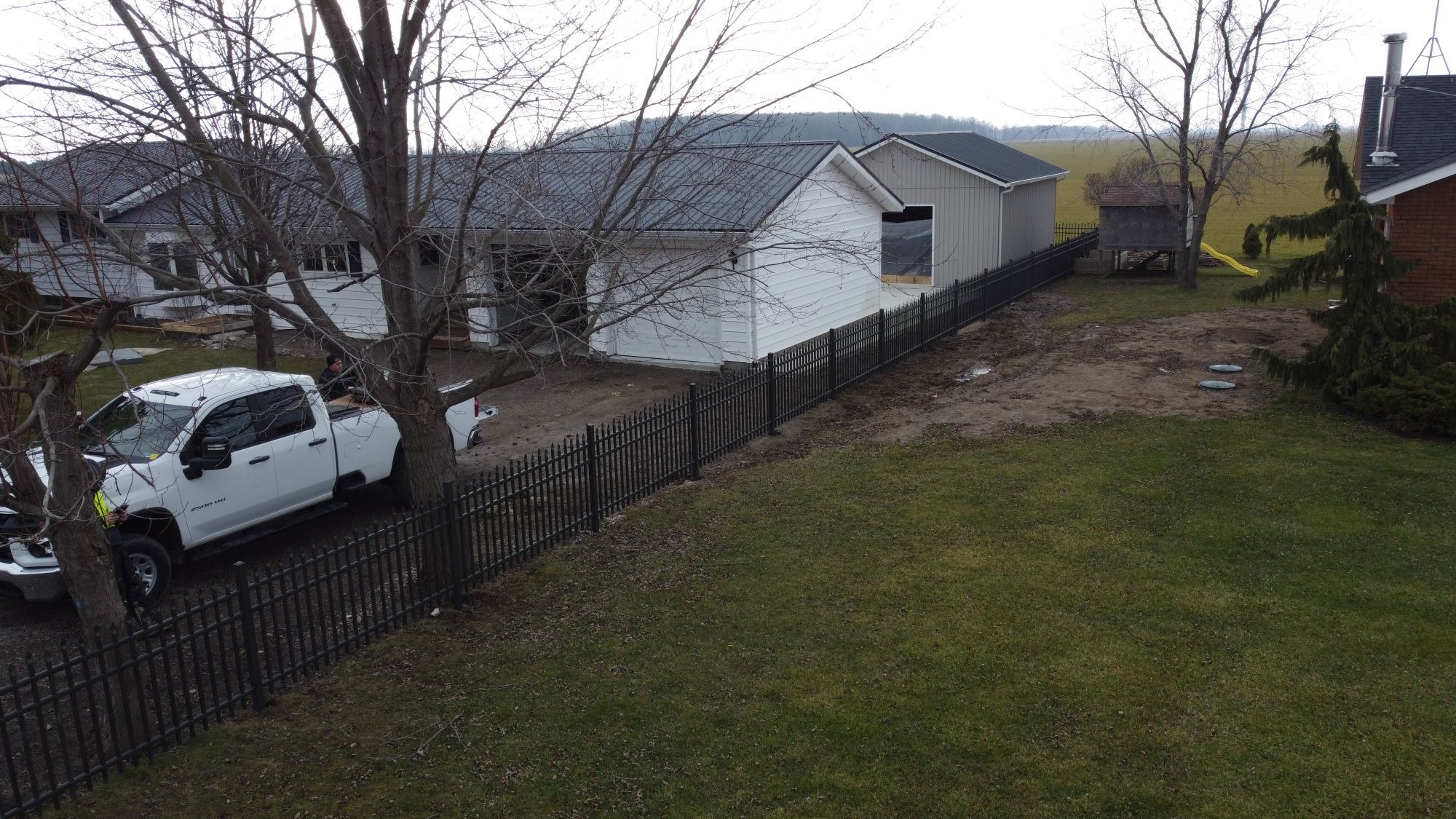 Four foot industrial fence around this home in Tilbury Ontario, we took advantage of that Matte Quaker Bronze does not show dirt or debris as easily, which means that it requires less frequent cleaning and maintenance.