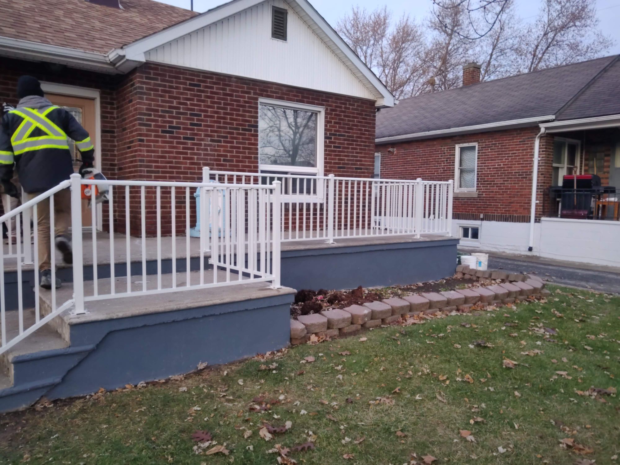 White aluminum porch railing in Leamington. Clean elegant two rail profile with 1.625 top cover.